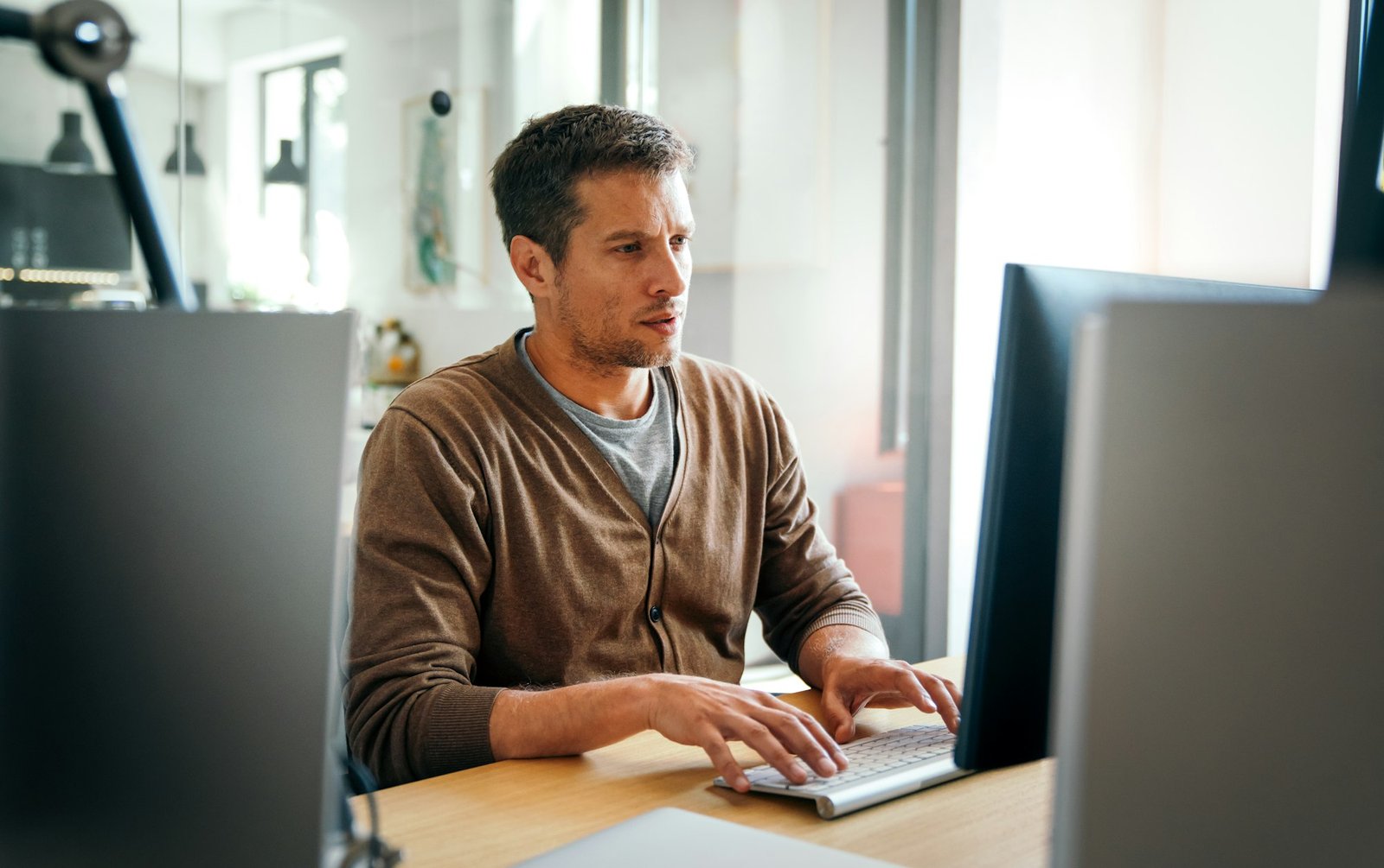 Programmer, web developer, designer working at office comparing mobile and desktop website versions